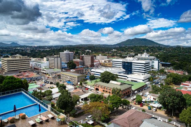 Aerial view of Lilongwe city skyline with buildings and mountains in the background