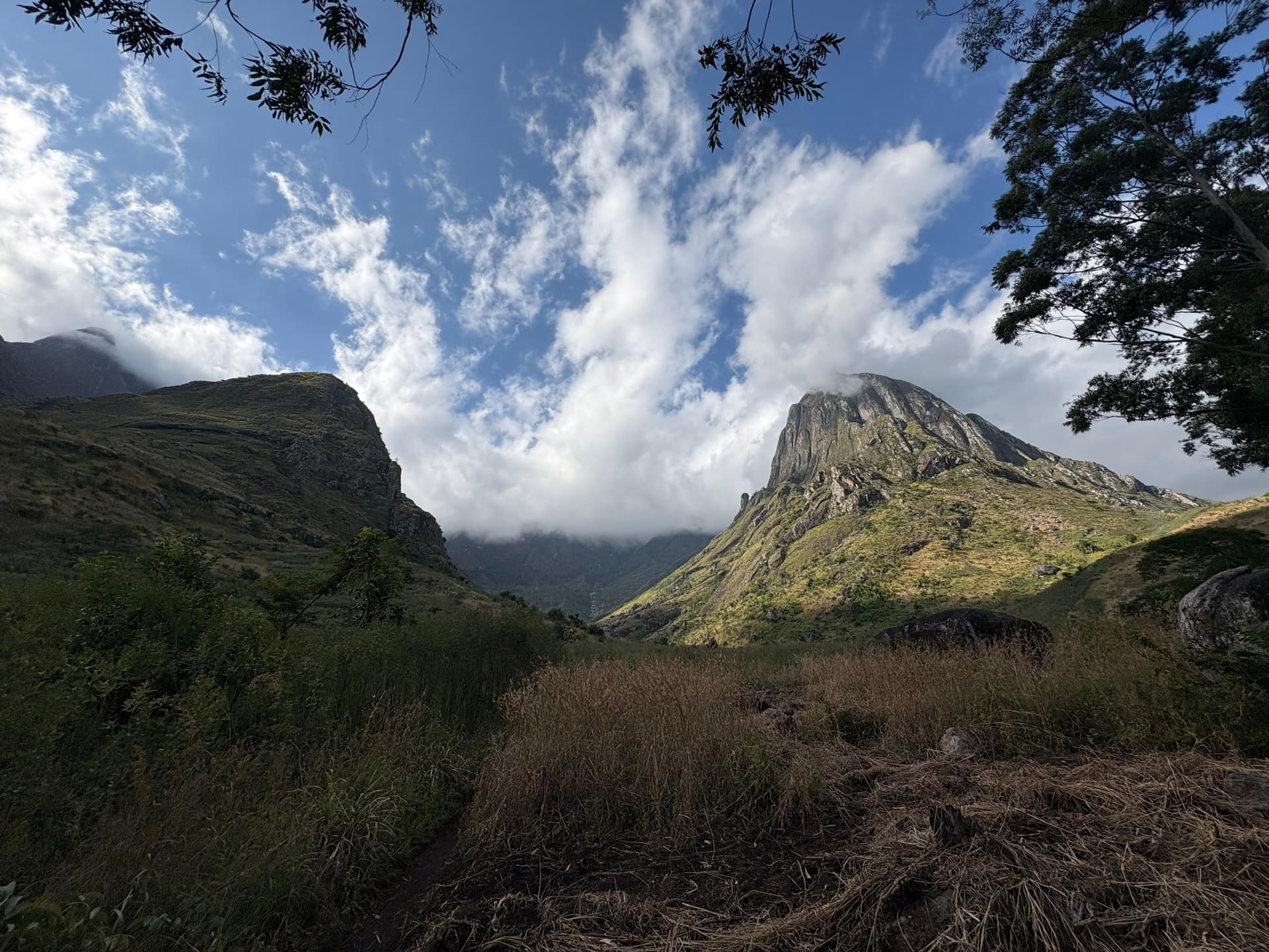 peak of Mount Mulanje surrounded by clouds and lush landscape in Malawi
